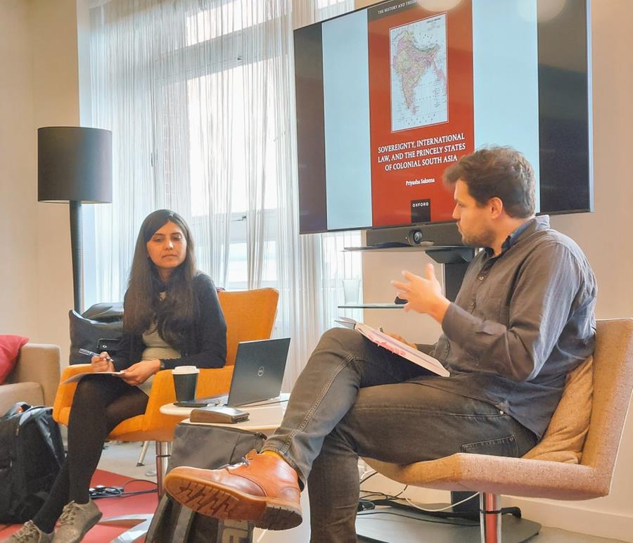 This is an image of Dr Priyasha Saksena discussing her book with Dimitri Van Den Meerssche.